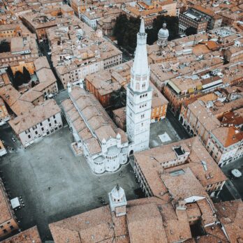 Explore the breathtaking aerial view of a historic Italian cathedral surrounded by charming old town rooftops.