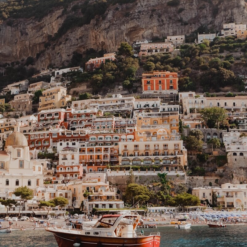 white and brown concrete buildings near body of water during daytime
