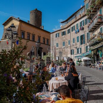 a group of people sitting at a table outside