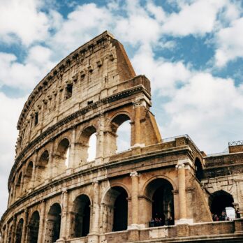 Colosseum under white clouds during daytime