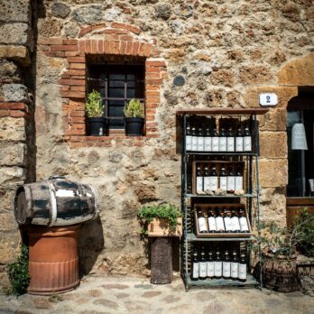 a stone building with a wine rack and a barrel