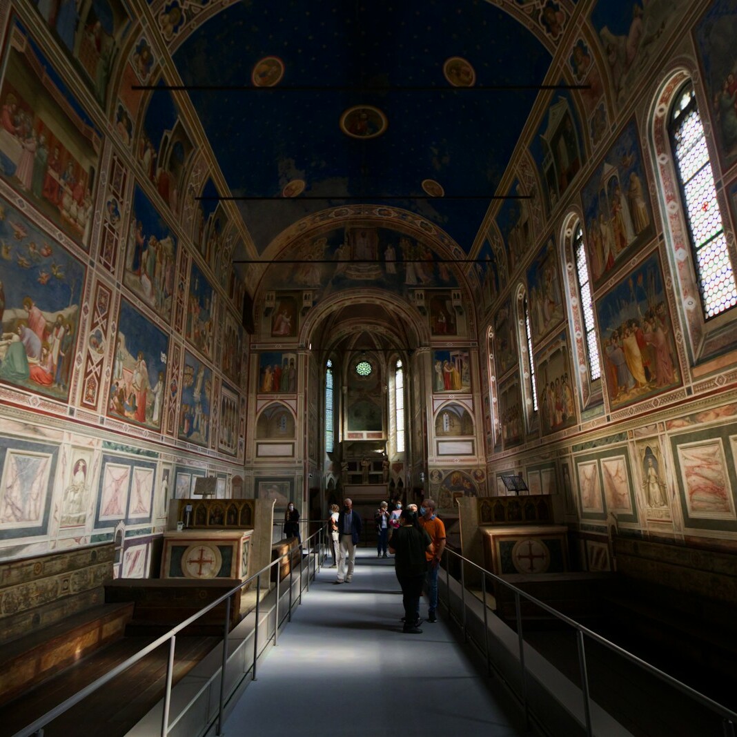 a long hallway with many paintings on the walls