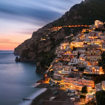 city buildings on mountain near body of water during daytime