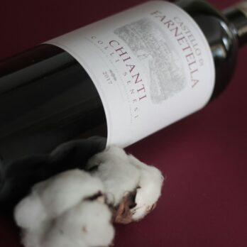 white labeled bottle on red table