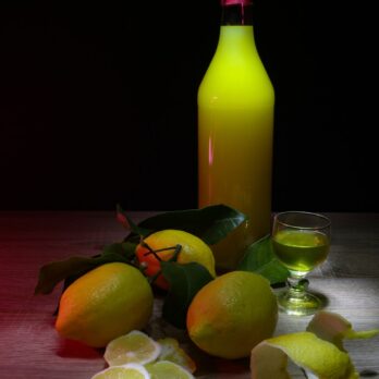 sliced lemon beside glass bottle