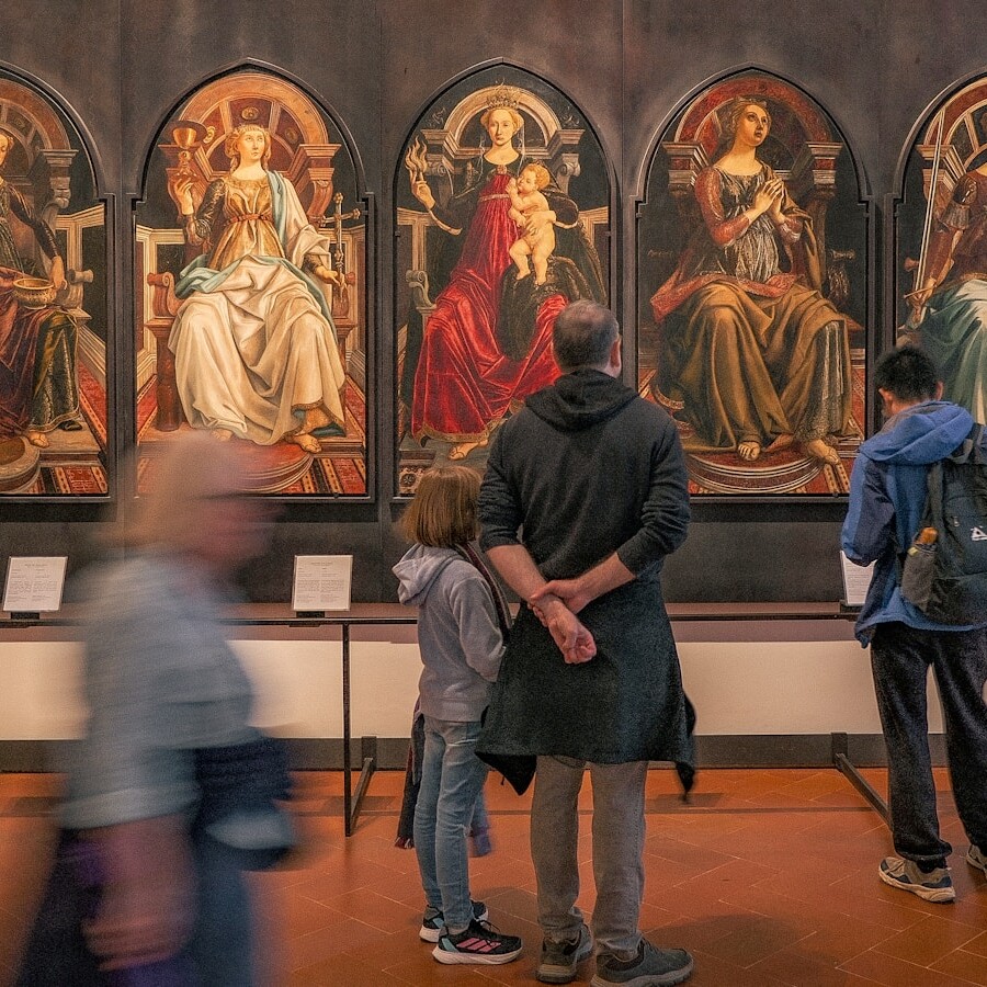 A group of people standing in front of a painting